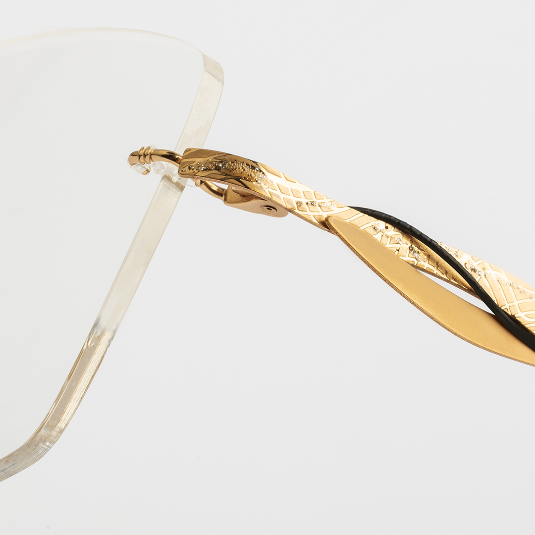 Detalle de la patilla dorada de gafa Flair sin monturas